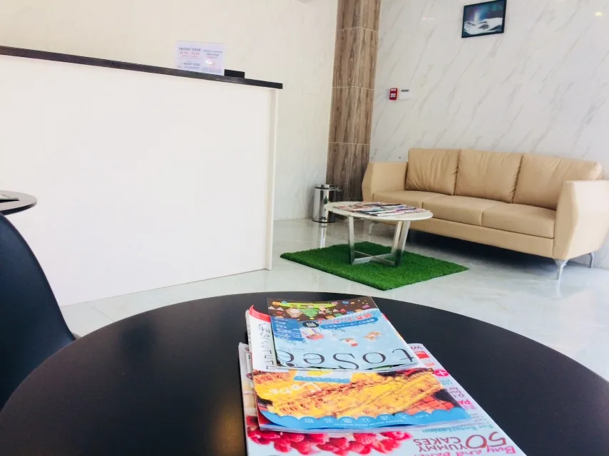 Hotel lobby reading table, sofa, and reception counter